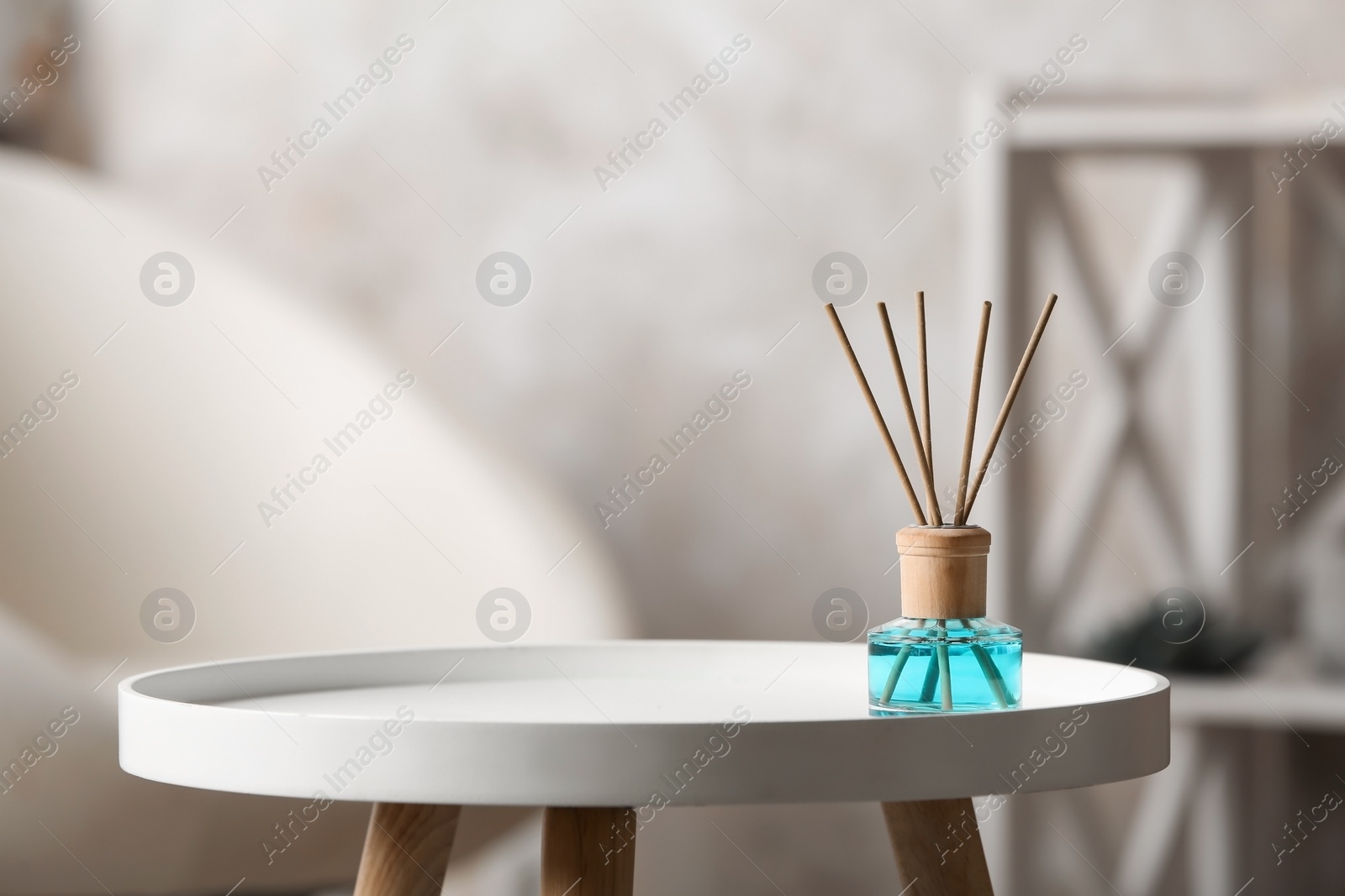 Photo of Reed air freshener on white table indoors, space for text