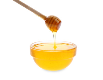 Photo of Honey dripping from dipper into bowl on white background