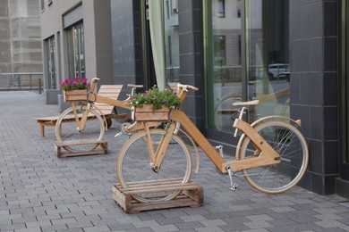 Bikes with beautiful flowers near building on city street