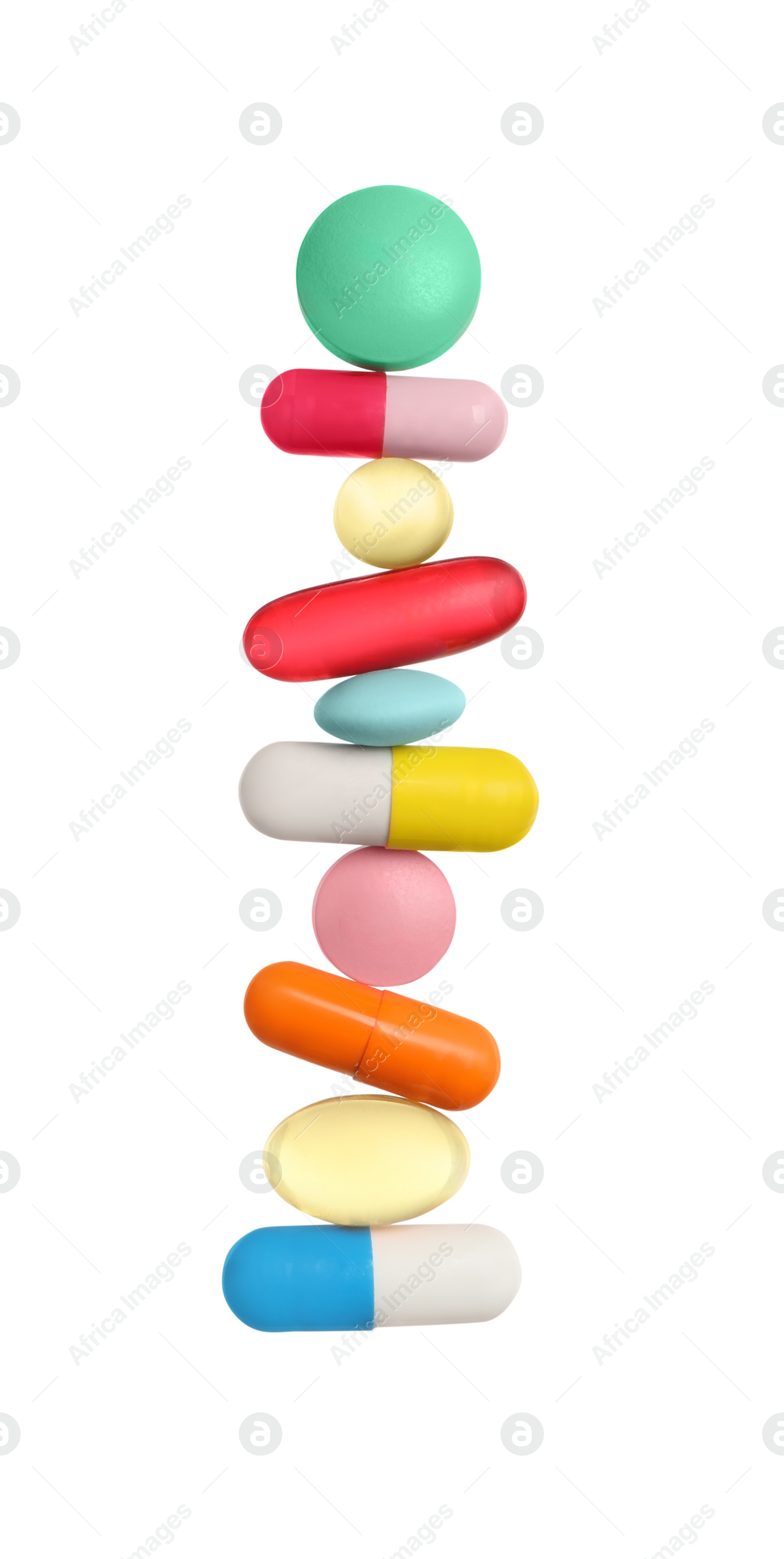 Photo of Stack of different colorful pills on white background