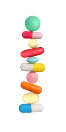 Stack of different colorful pills on white background