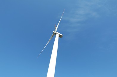 Photo of Modern wind turbine against blue sky, low angle view. Alternative energy source