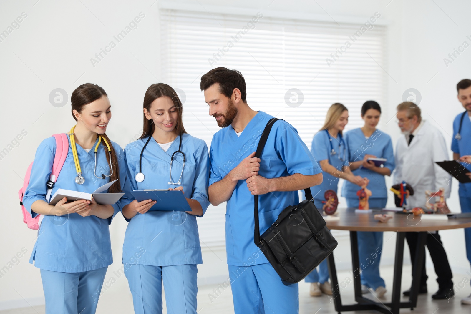 Photo of Medical students wearing uniforms in university hallway