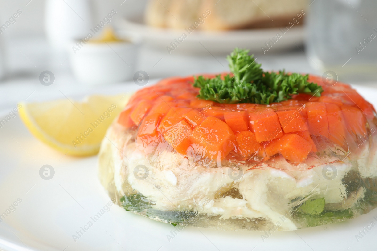 Photo of Delicious fish aspic with parsley on plate, closeup