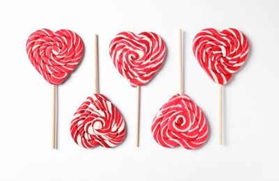 Sweet heart shaped lollipops on white background, flat lay. Valentine's day celebration