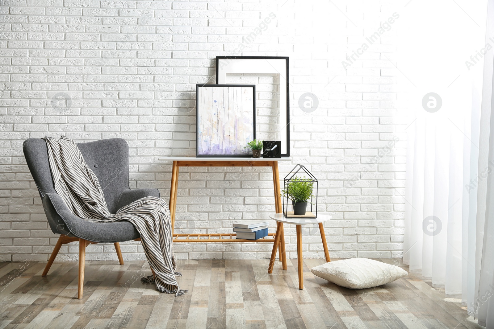 Photo of Stylish living room interior with comfortable armchair near brick wall. Space for text