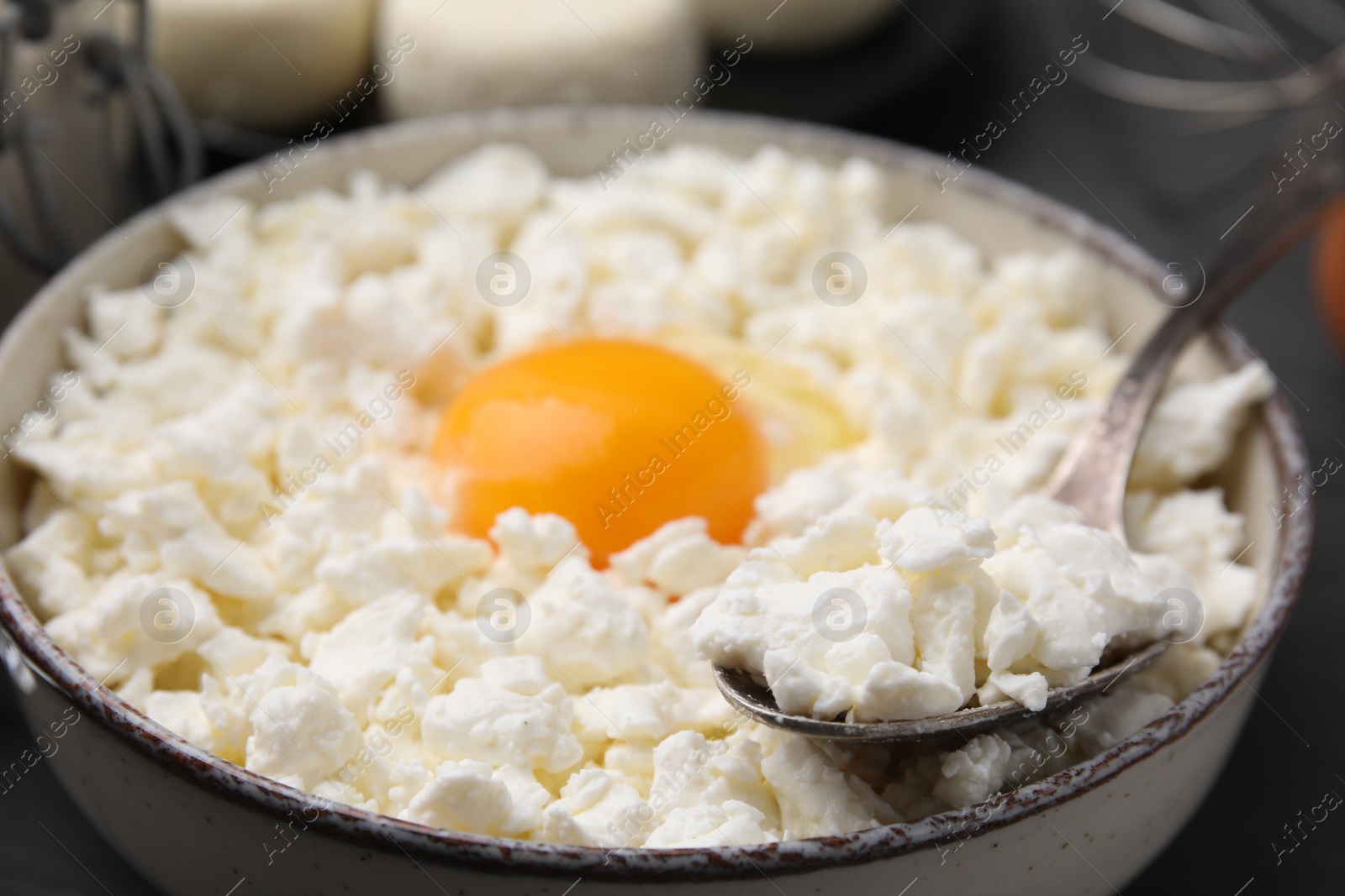 Photo of Bowl with ingredients for cooking cottage cheese pancakes, closeup