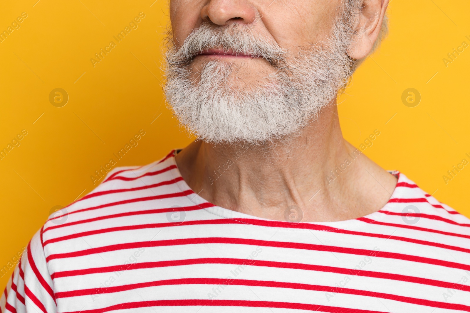 Photo of Man with mustache on orange background, closeup