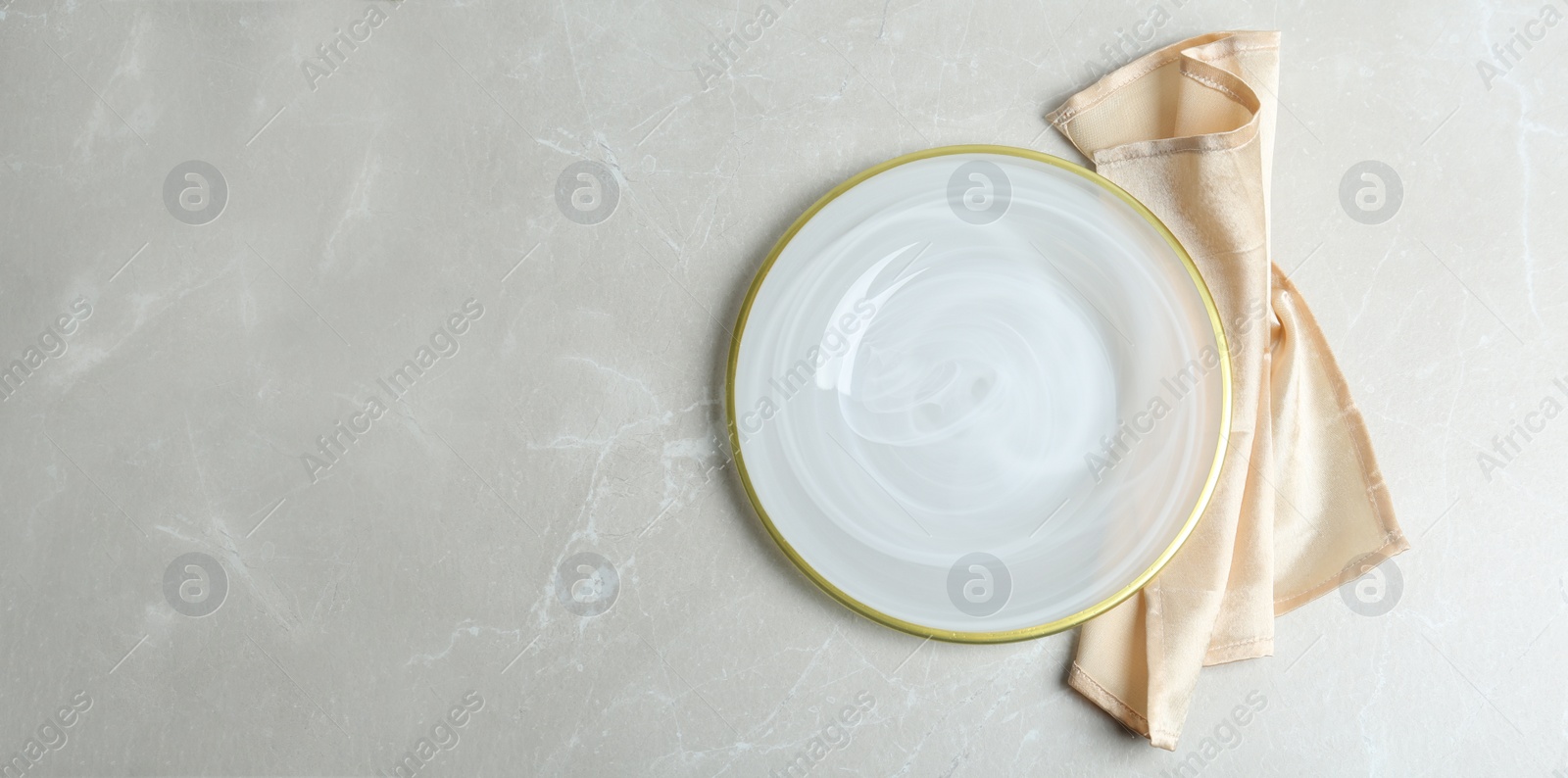 Photo of Empty plate and napkin on light grey marble table, flat lay