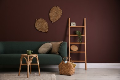 Comfortable wooden stool near sofa in living room