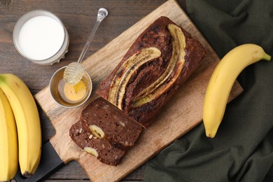 Photo of Delicious banana bread served on wooden table, flat lay