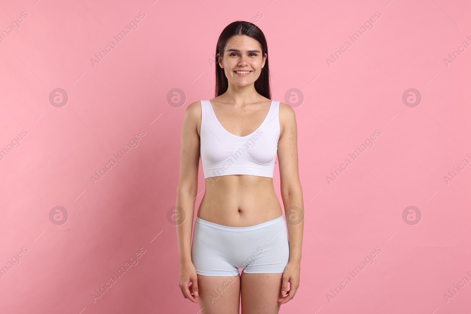 Photo of Happy slim woman on pink background. Weight loss
