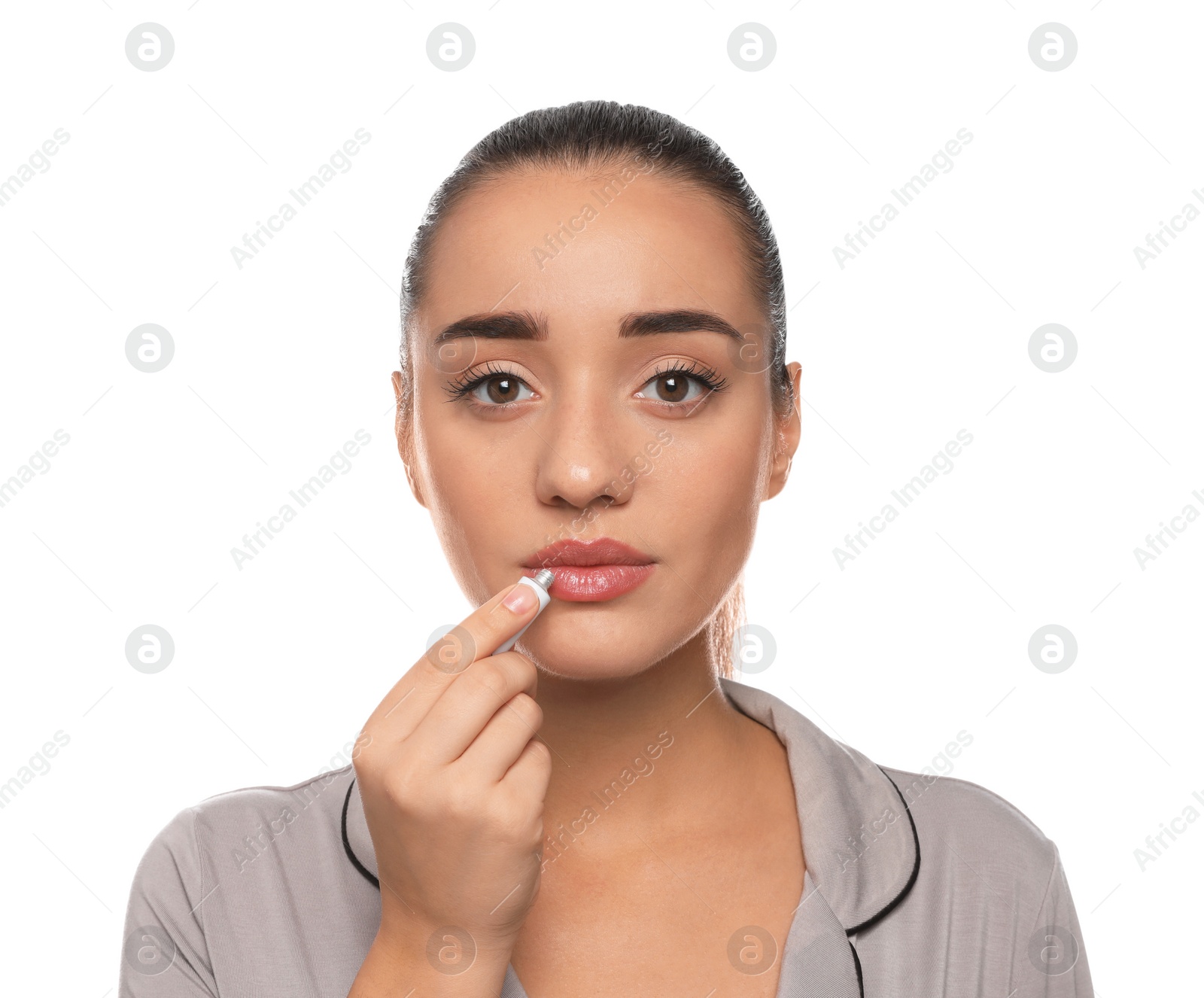 Photo of Woman with herpes applying cream on lips against white background