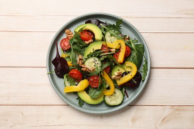 Photo of Balanced diet and vegetarian foods. Plate with different delicious products on wooden table, top view