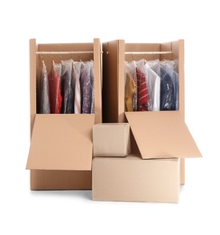 Photo of Wardrobe boxes with clothes on white background