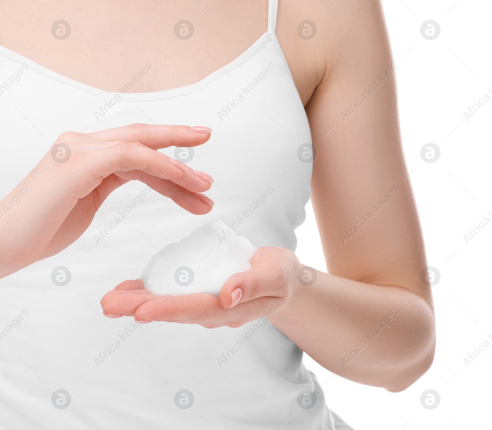 Photo of Woman with cleansing foam on hands against white background, closeup