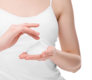 Woman with cleansing foam on hands against white background, closeup