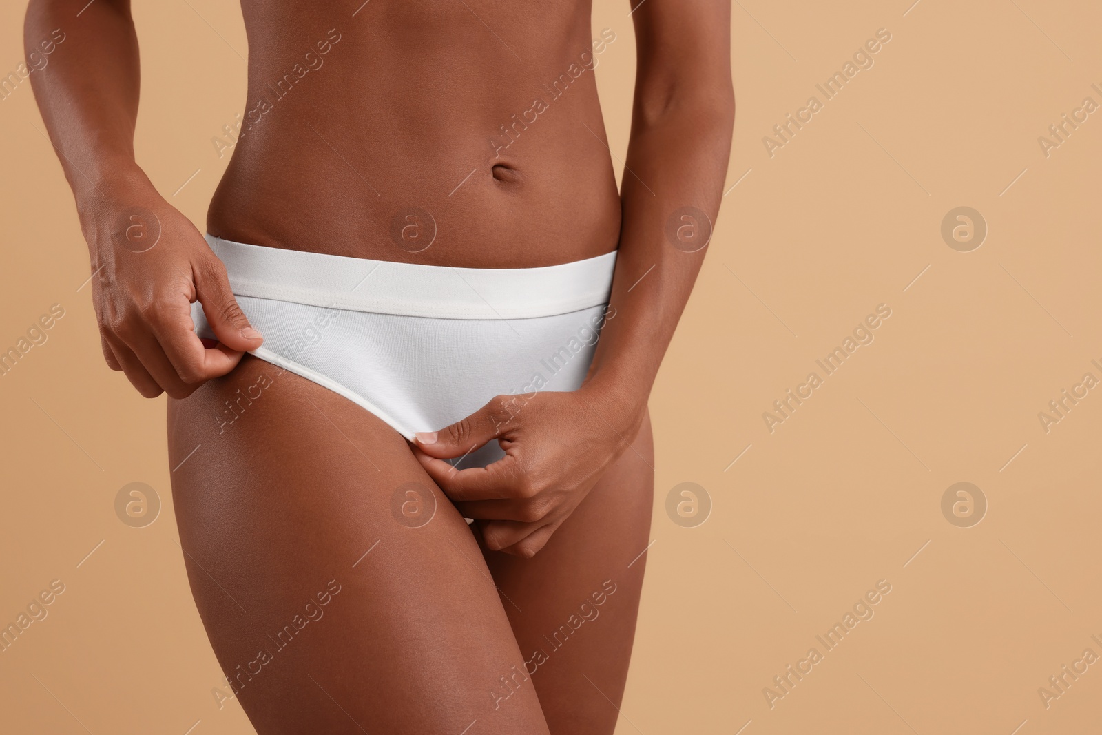 Photo of Woman in stylish bikini on beige background, closeup. Space for text