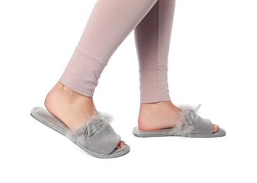 Woman in grey soft slippers on white background, closeup