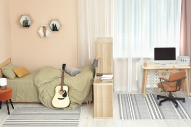 Stylish teenager's room interior with comfortable bed and workplace