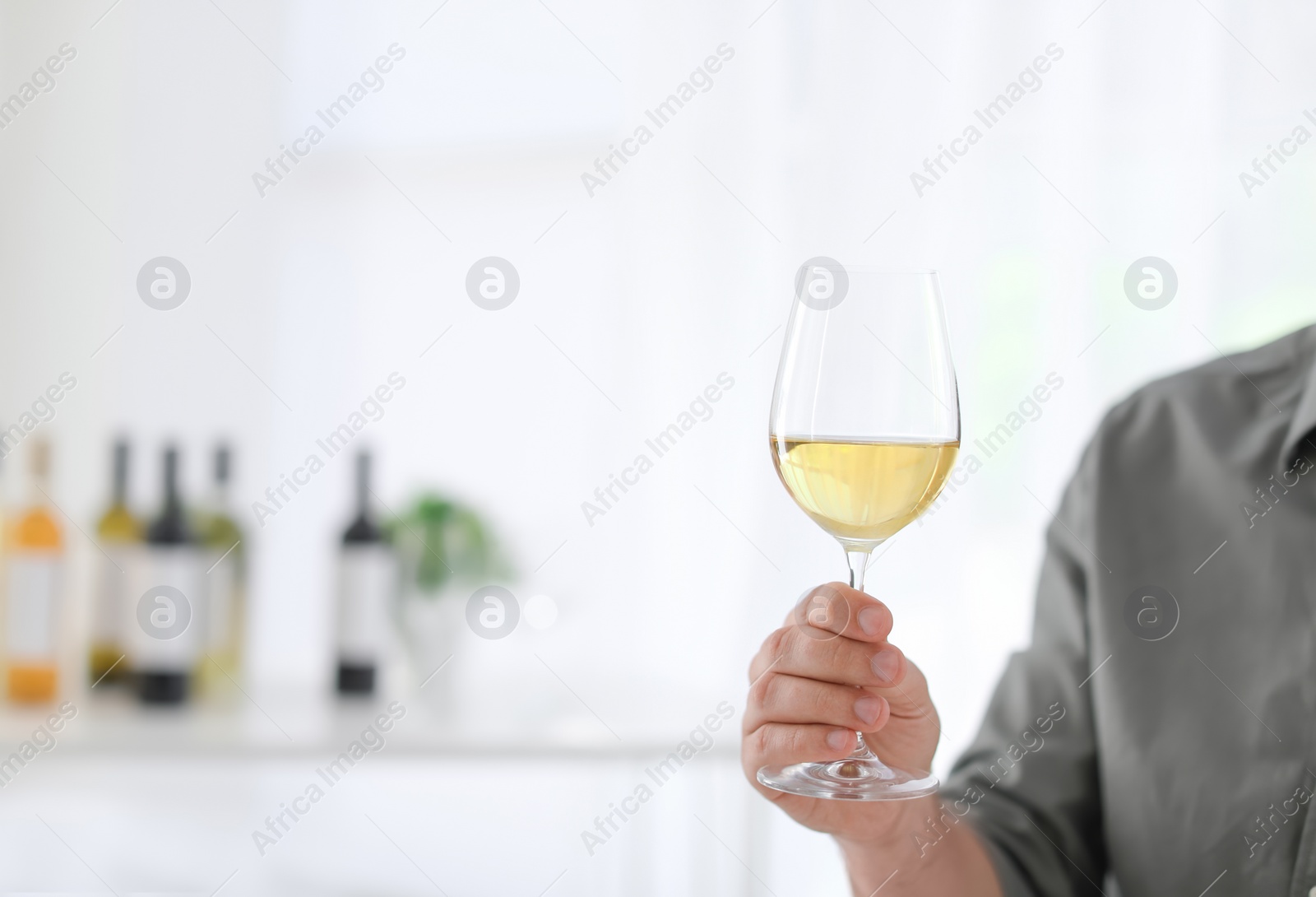 Photo of Young man with glass of wine indoors