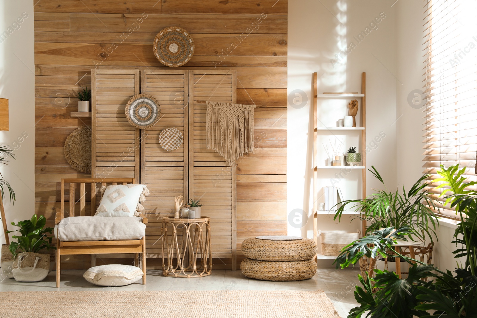 Photo of Stylish living room interior with comfortable wooden armchair and beautiful houseplants