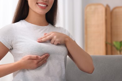 Photo of Woman doing breast self-examination at home, closeup. Space for text