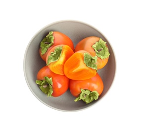 Photo of Bowl with delicious fresh persimmons isolated on white, top view