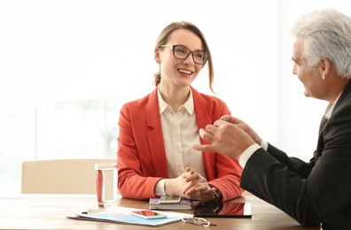 Mature man consulting with woman in office