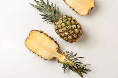 Photo of Fresh pineapples on light background, flat lay