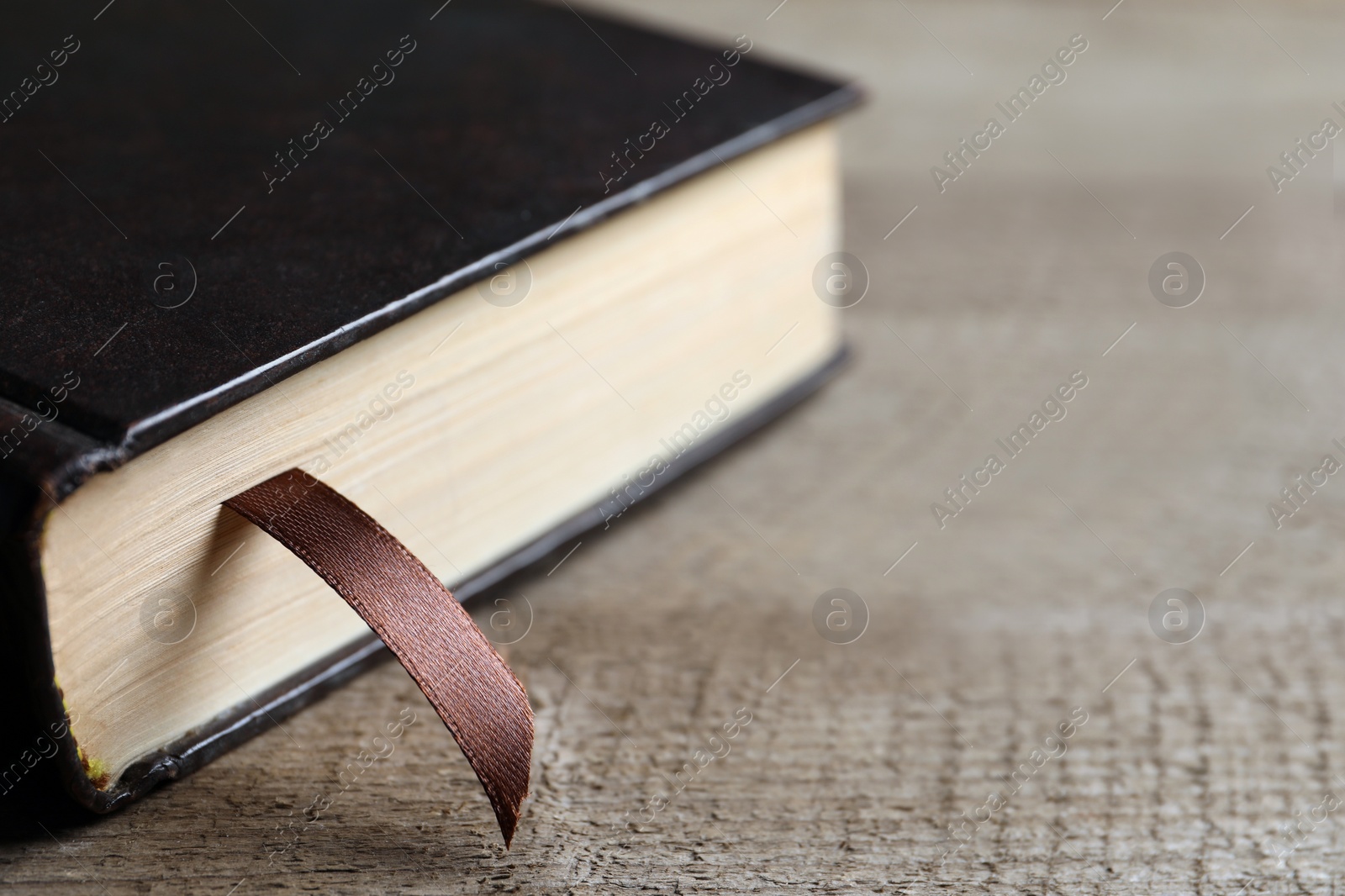 Photo of Holy Bible on wooden table, closeup. Space for text