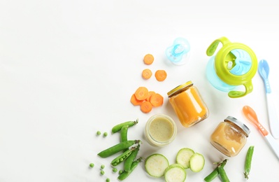 Photo of Flat lay composition with baby food, ingredients and accessories on light background