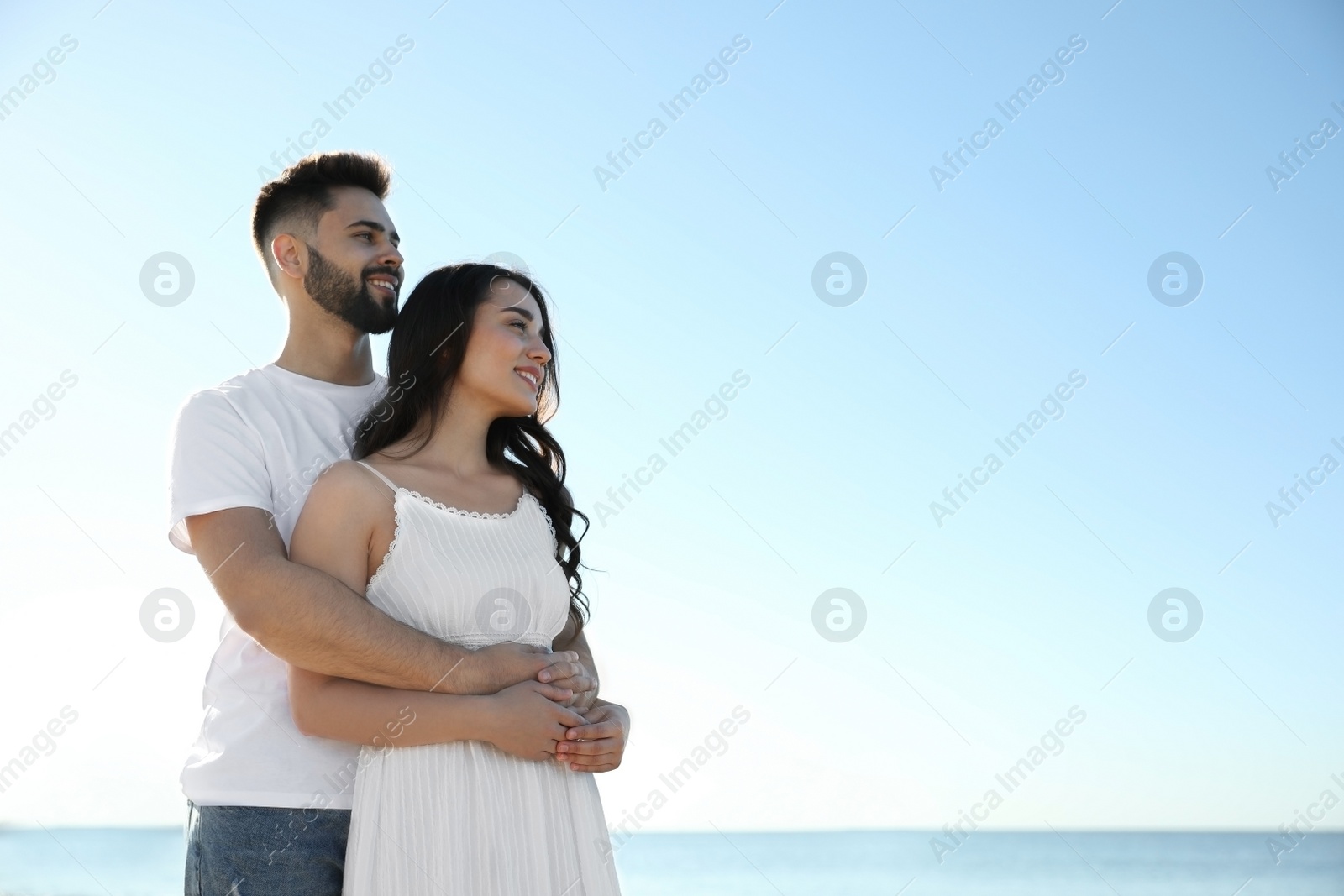 Photo of Happy young couple at beach. Honeymoon trip