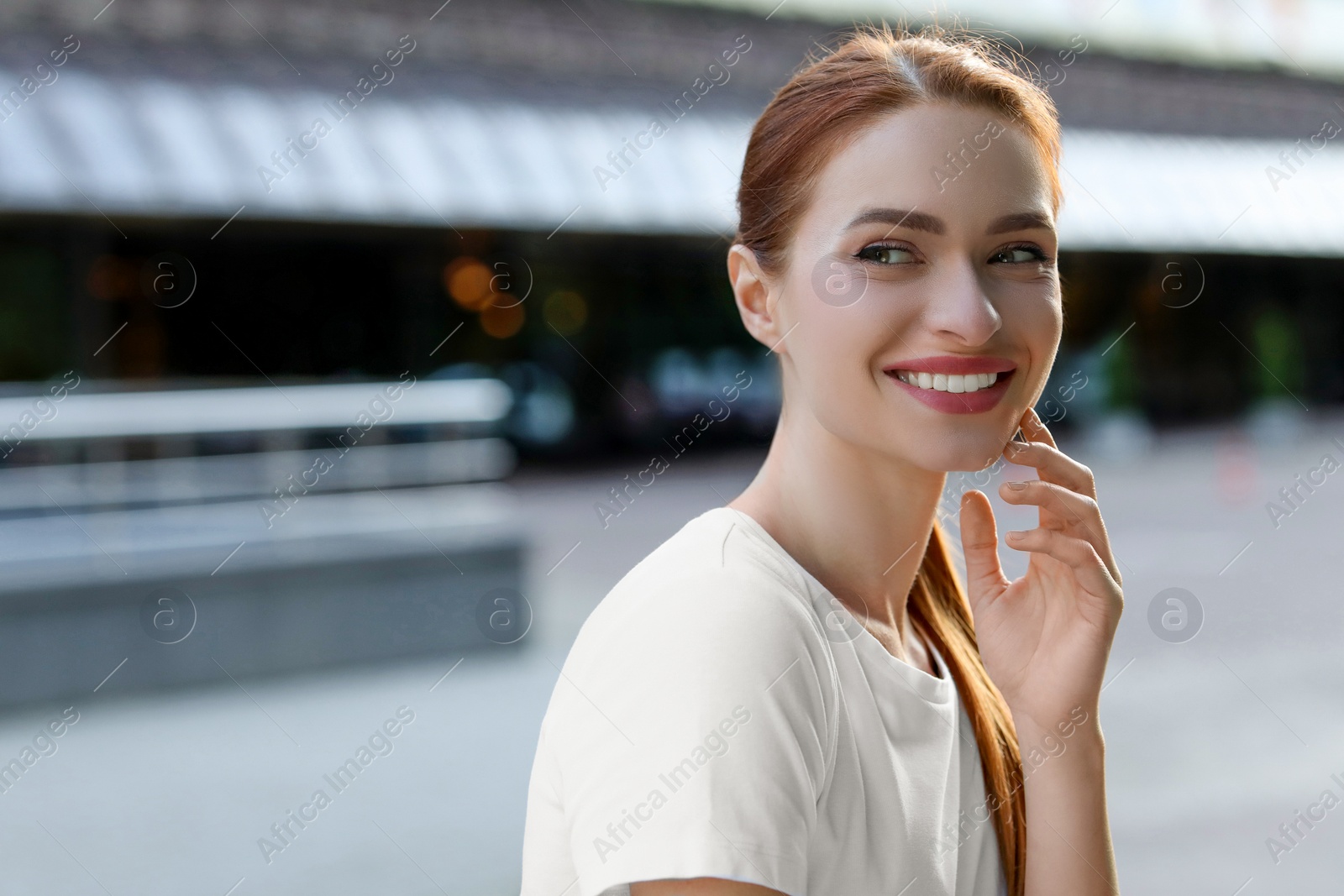 Photo of Portrait of happy young woman outdoors. Space for text. Attractive lady smiling and posing for camera