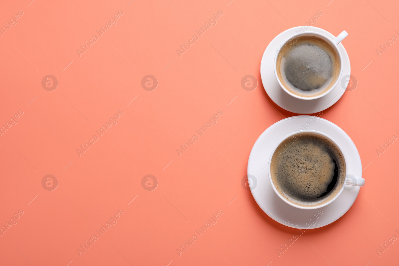 Photo of 8 March greeting card design with cups of coffee and  space for text on coral background, flat lay. International Women's day