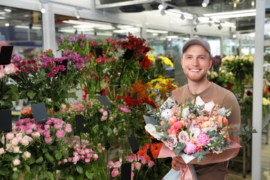 Image of Delivery man with beautiful bouquet in flower shop