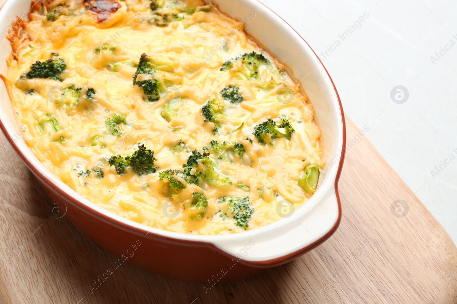 Photo of Tasty broccoli casserole in baking dish on table