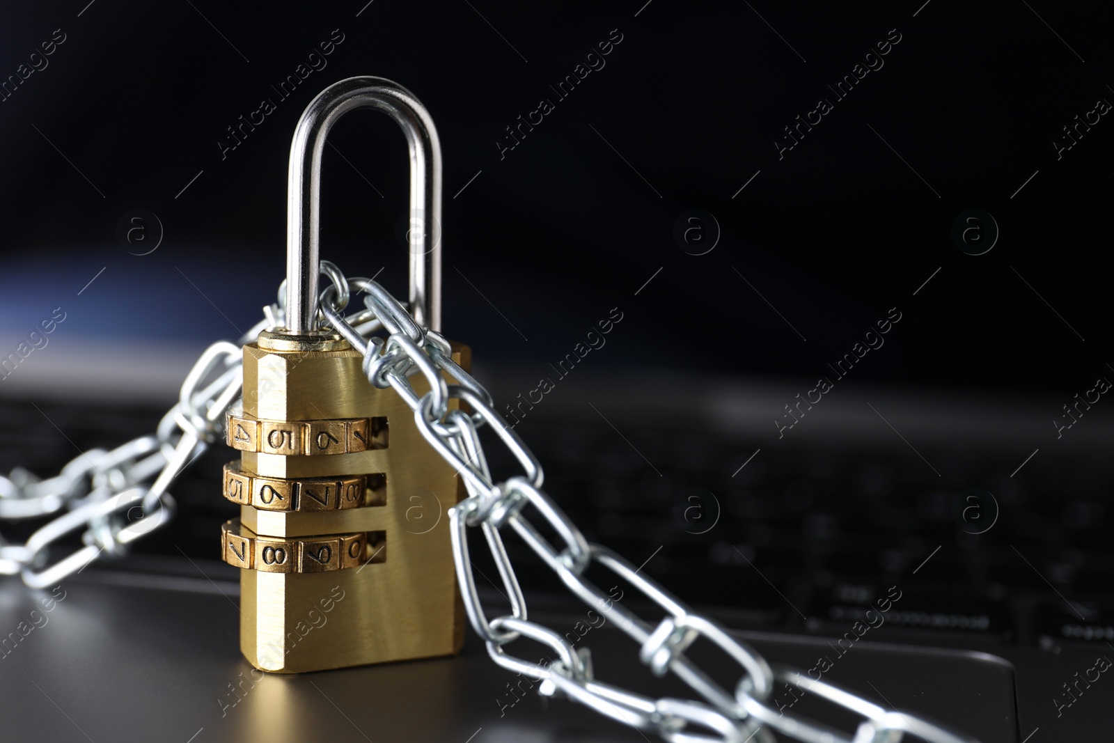 Photo of Cyber security. Padlock with chain on laptop, closeup