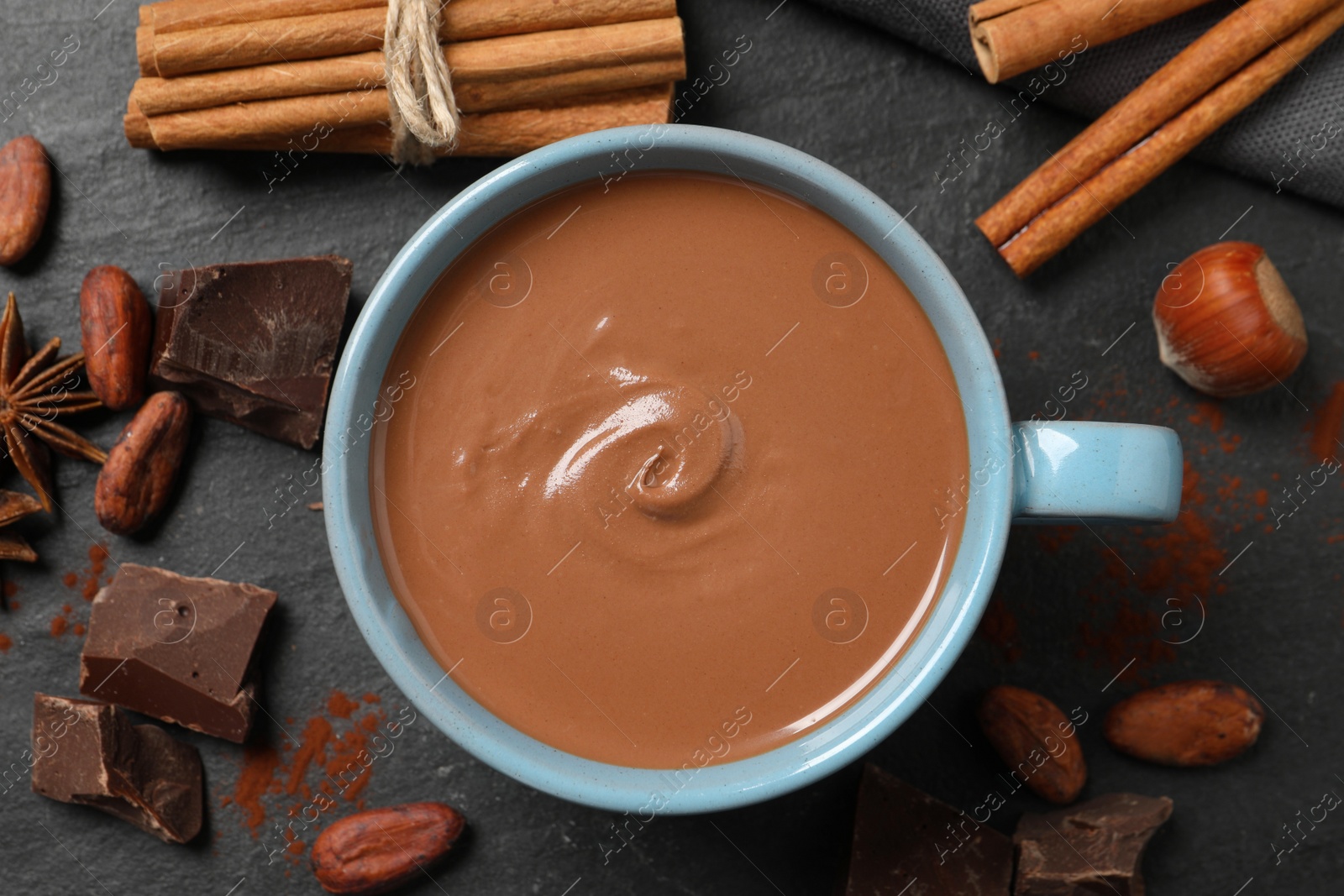 Photo of Flat lay composition with yummy hot chocolate on black table