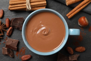 Photo of Flat lay composition with yummy hot chocolate on black table