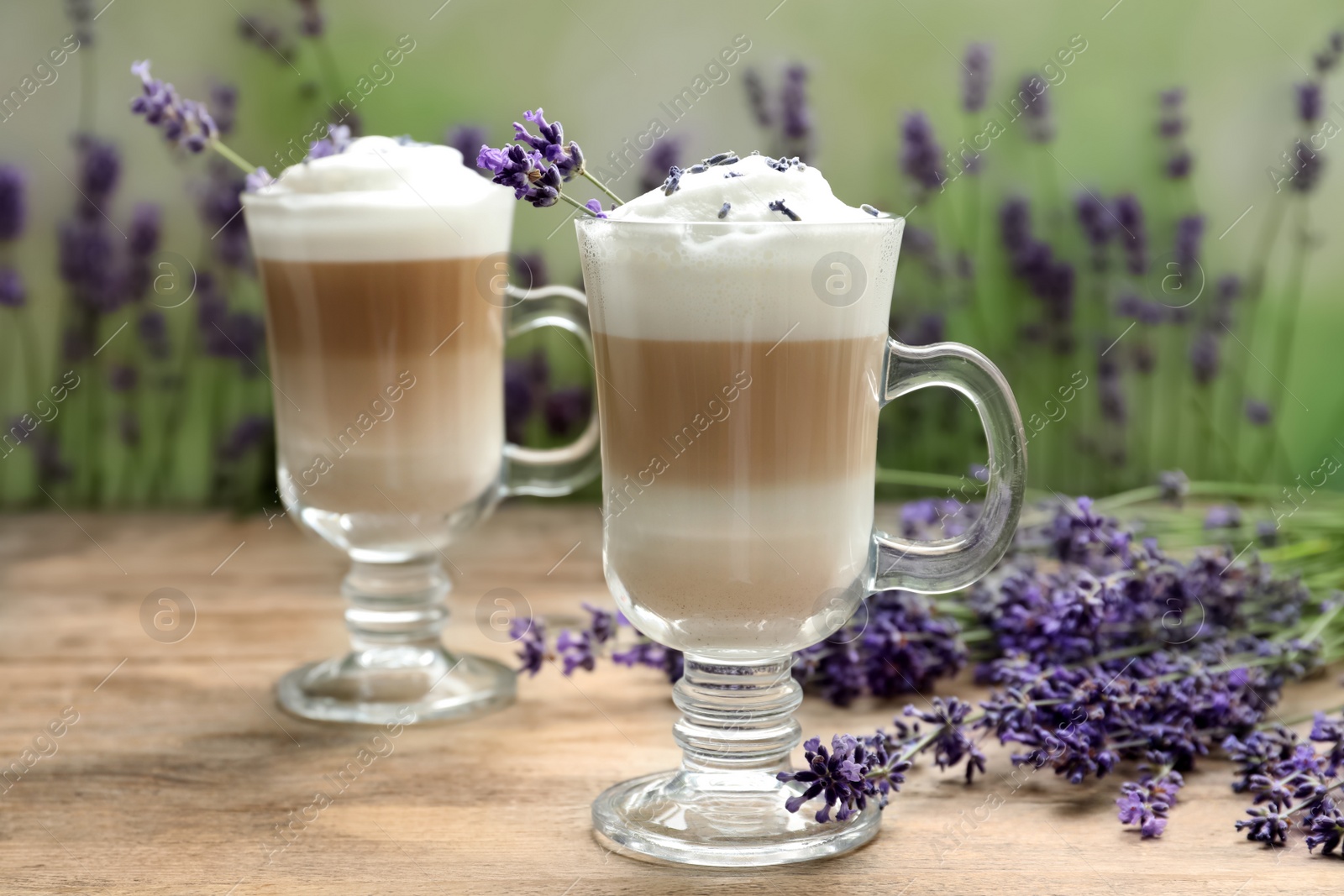 Photo of Delicious latte with lavender on wooden table