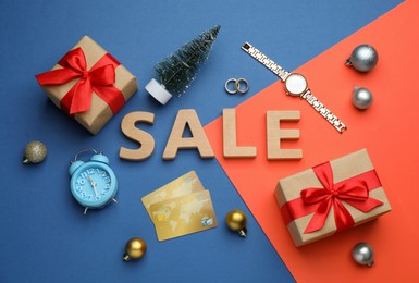 Photo of Flat lay composition with word Sale on color background