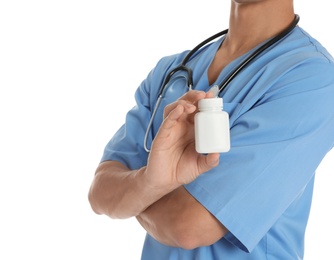 Male doctor holding pill bottle on white background, closeup with space for text. Medical object