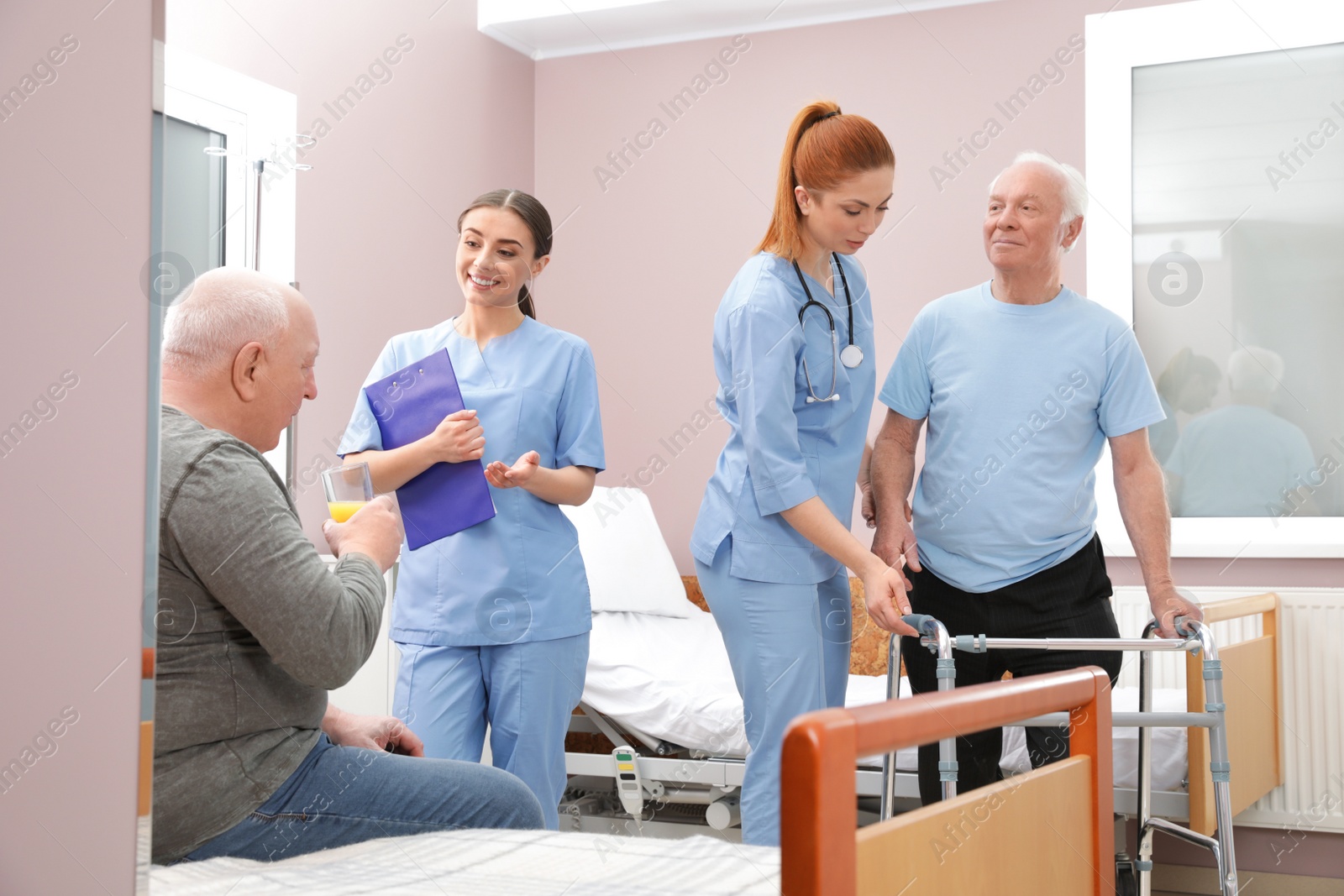 Photo of Nurses with senior patients in hospital ward. Medical assisting