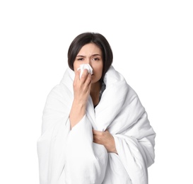 Photo of Young woman wrapped in blanket  suffering from cold on white background