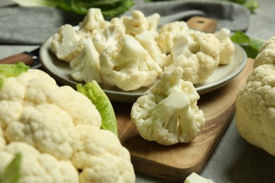 Cut fresh raw cauliflowers on grey table, closeup