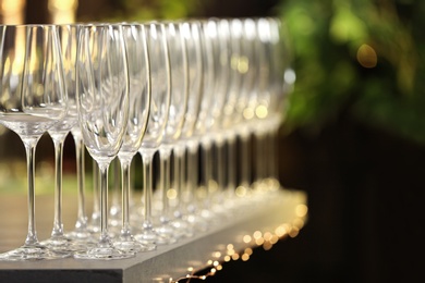 Set of empty glasses on grey table against blurred background