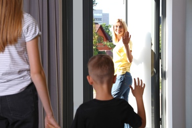 Mother leaving her little son with teen nanny at home