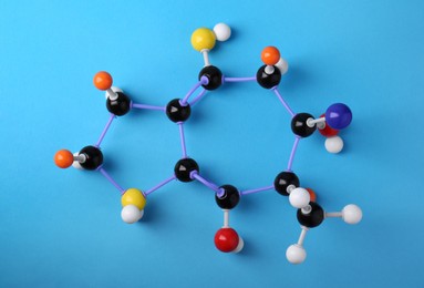 Photo of Structure of molecule on light blue background, top view. Chemical model