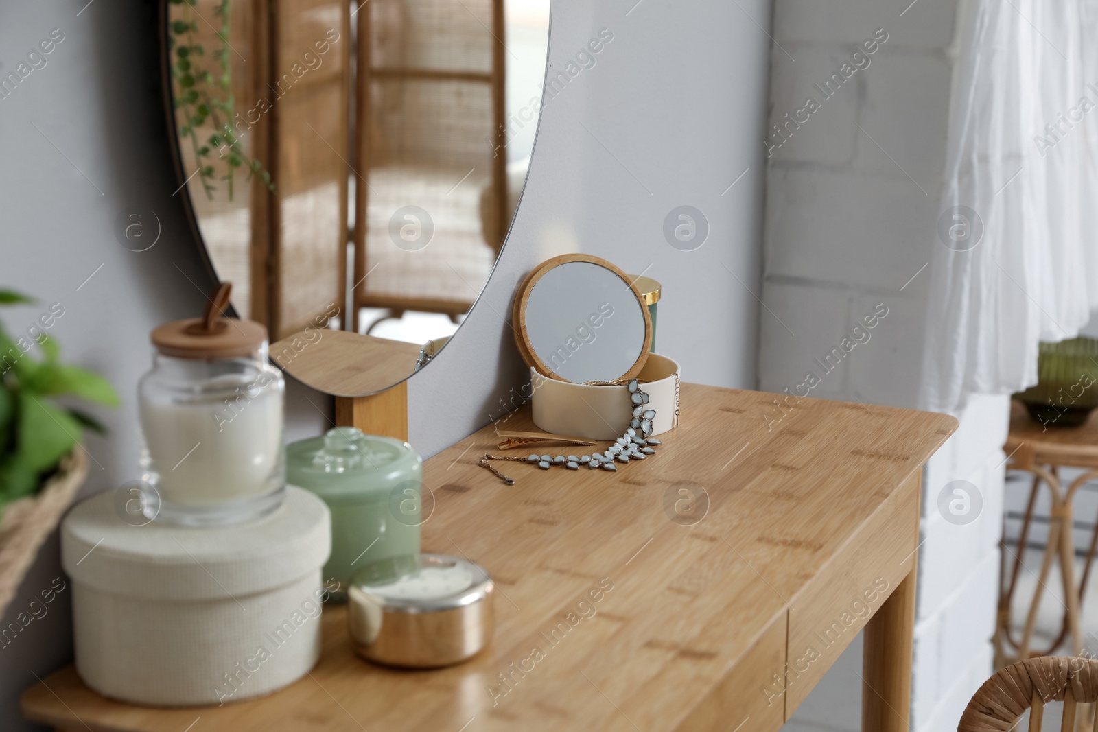 Photo of Wooden dressing table with decorative elements in room